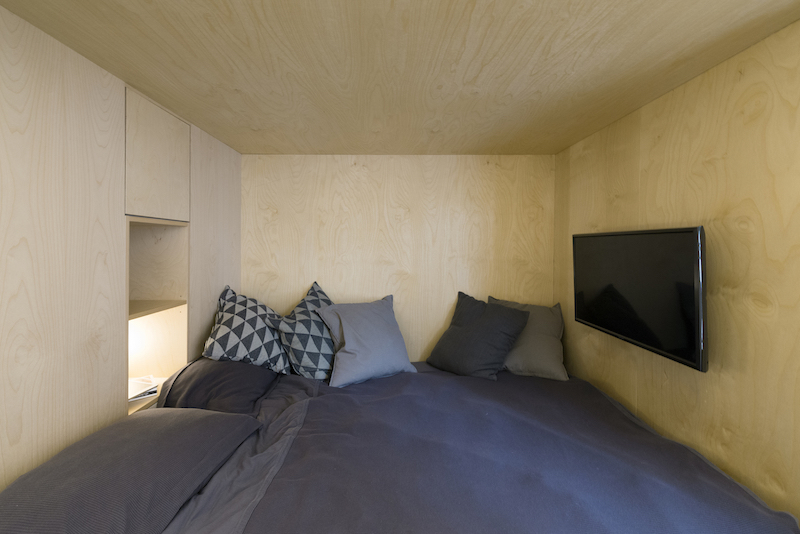 The top bunk is really cozy. It has a TV, mood lighting and even storage space on shelves