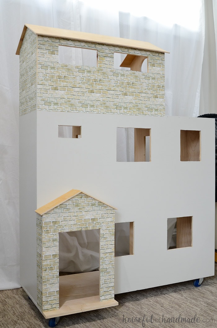 Handmade dollhouse painted white with brick