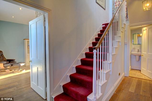 A pop of colour has been introduced in this hallway in a property for sale in Alnmouth, Northumberland