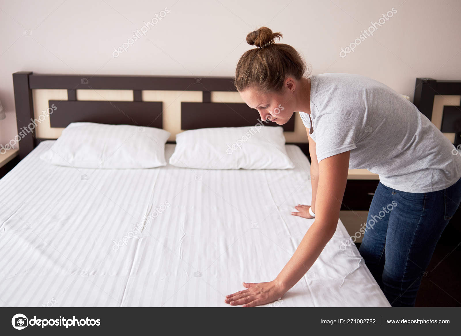 depositphotos 271082782 stock photo beautiful young woman making bed