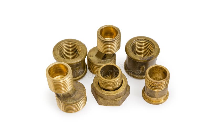 Brass eccentric connectors and other threaded plumbing component. Brass eccentric connectors, pipe couplings and other threaded plumbing components on a white stock image