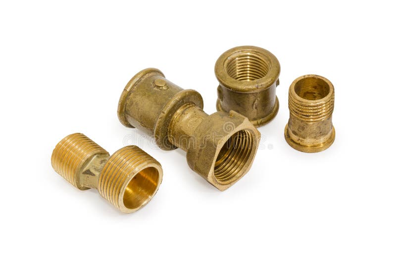 Different brass pipe fittings and plumbing components on white b. Brass eccentric connector, pipe couplings and other plumbing components on a white background stock photo