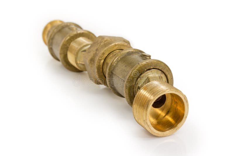 Several connected brass plumbing components at selective focus. Several connected brass pipe couplings and other threaded plumbing components closeup at royalty free stock images